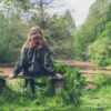 Woman sitting on bench by pond 54321 Grounding Technique aware of senses